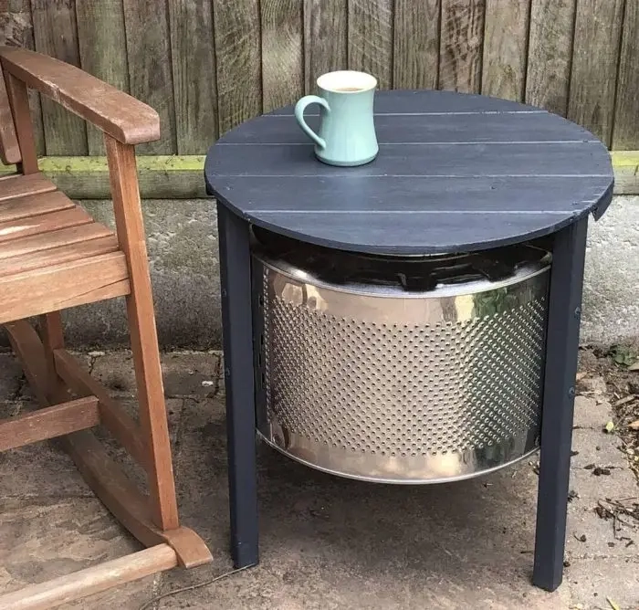 Looking for an innovative way to upcycle a washing machine?? Make yourself a washing machine drum coffee table, with some scrap wood and paint. #washingmachinedrum #DIYcoffeetable
